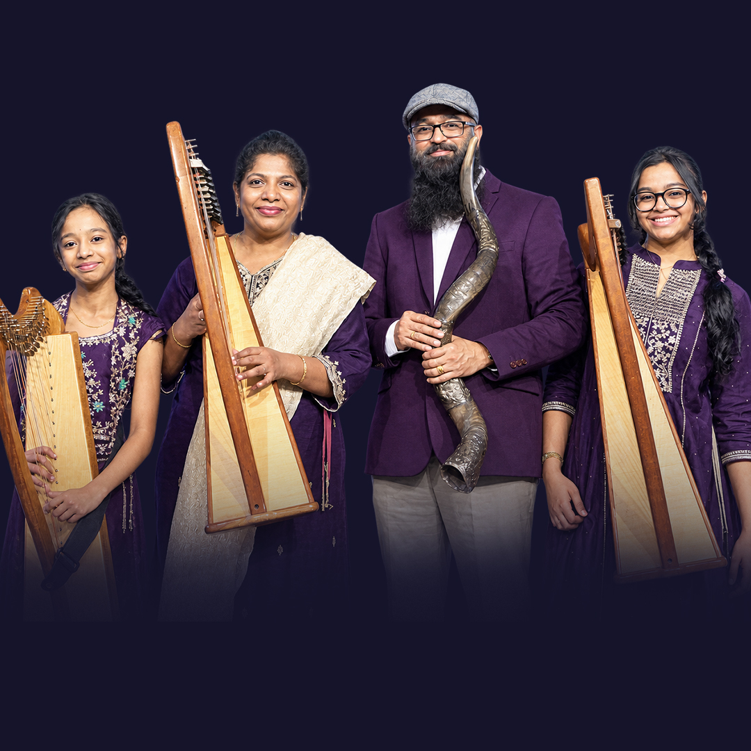 Ps. Kiran Bala with his wife and three daughters, holding a shofar and harps